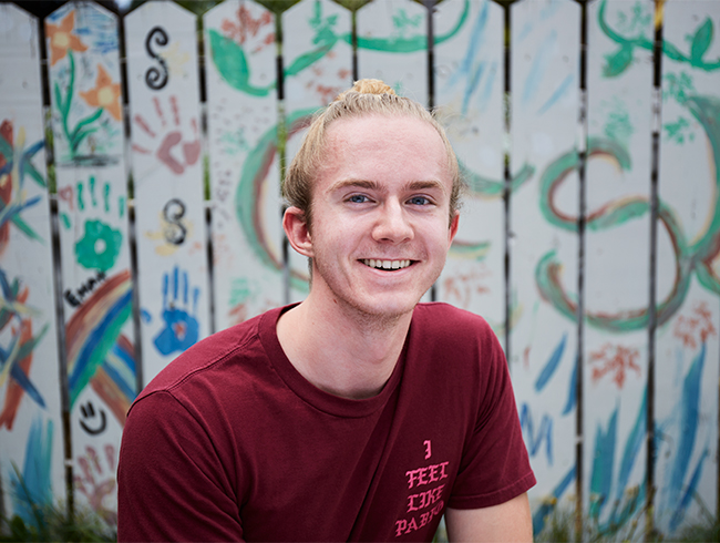 student headshot in front of painted wall