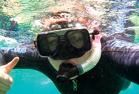 student snorkling in ocean