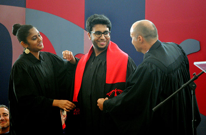 student being draped with shawl at graduation