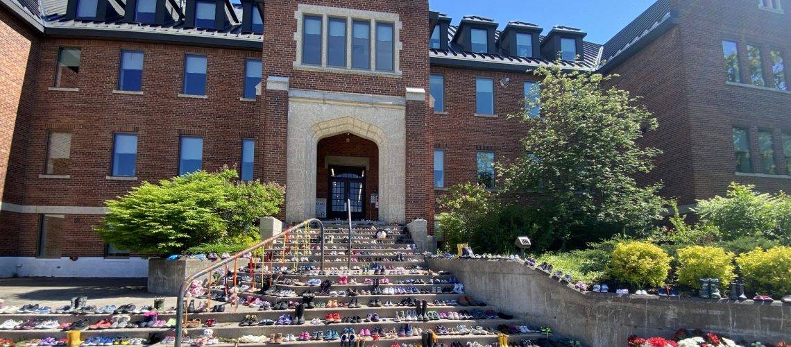 Shoes on front steps of Shingwauk Hall