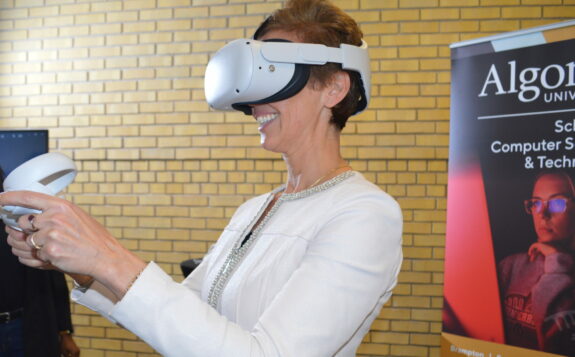 Algoma University President and Vice-Chancellor Asima Vezina testing Unity AR/VR platform at NCoE launch in Brampton