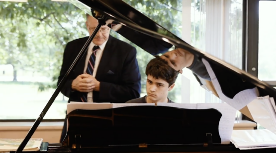 Student at piano with professor