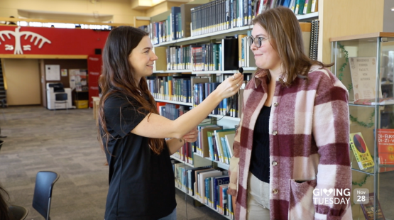 Thumbnail for video, Interviewer holding microphone toward student