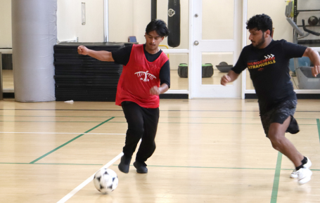 Two GTA students playing Intramural Soccer