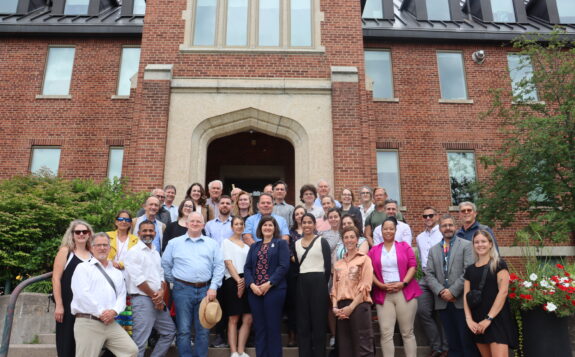 Group photo of IJC on the steps of Shingwauk Hall with members of the AU team