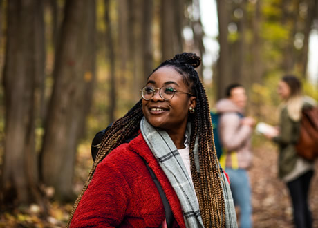 Three Female Friends Having Fun and Enjoying Hiking in Forest
